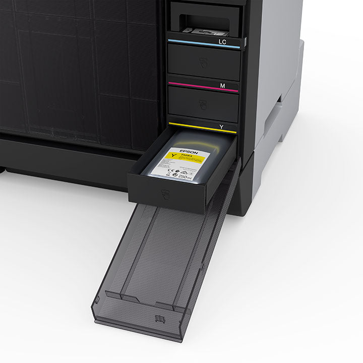 A close-up of the Epson SureLab D1070DE Professional Minilab Photo Printer shows its front panel open, revealing four labeled ink cartridge slots. The yellow cartridge is partially pulled out, while cyan, magenta, and light cyan slots stay closed.