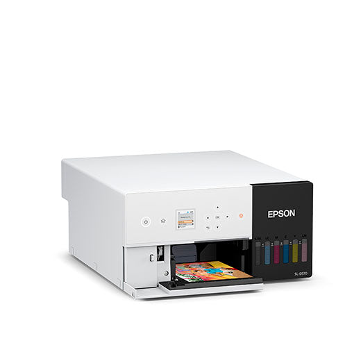 The Epson SureLab D570 Professional Minilab Photo Printer (SLD570SE) by Epson, a white small-format printer with a control panel and visible ink tanks, prints a vibrant photo on a plain white background.