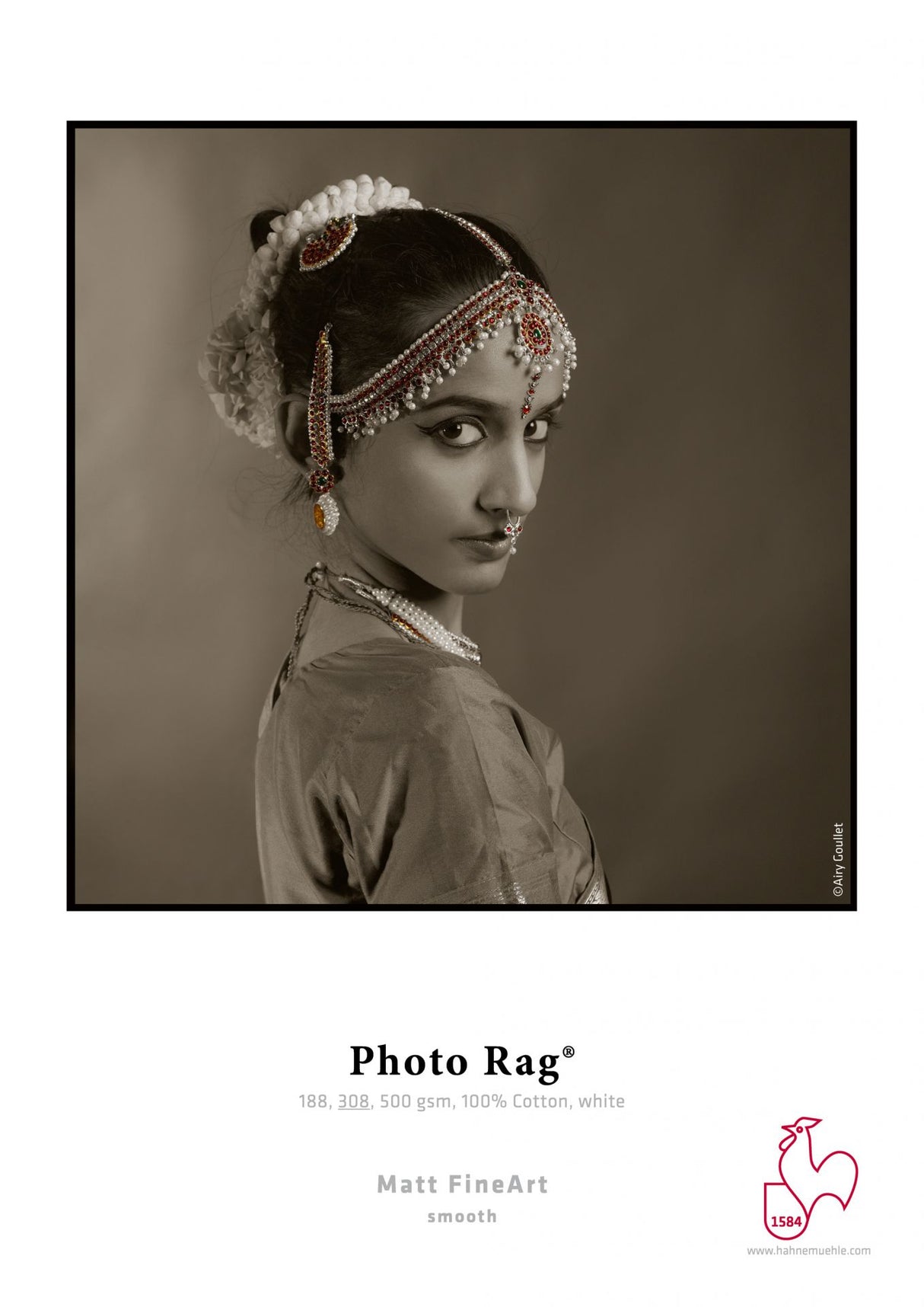 A woman in traditional Indian attire with ornate jewelry gazes over her shoulder in this sepia portrait. The detailed headpiece and nose ring stand out, printed on Hahnemuhle’s Hahnemühle Photo Rag® (308) high-quality art paper.