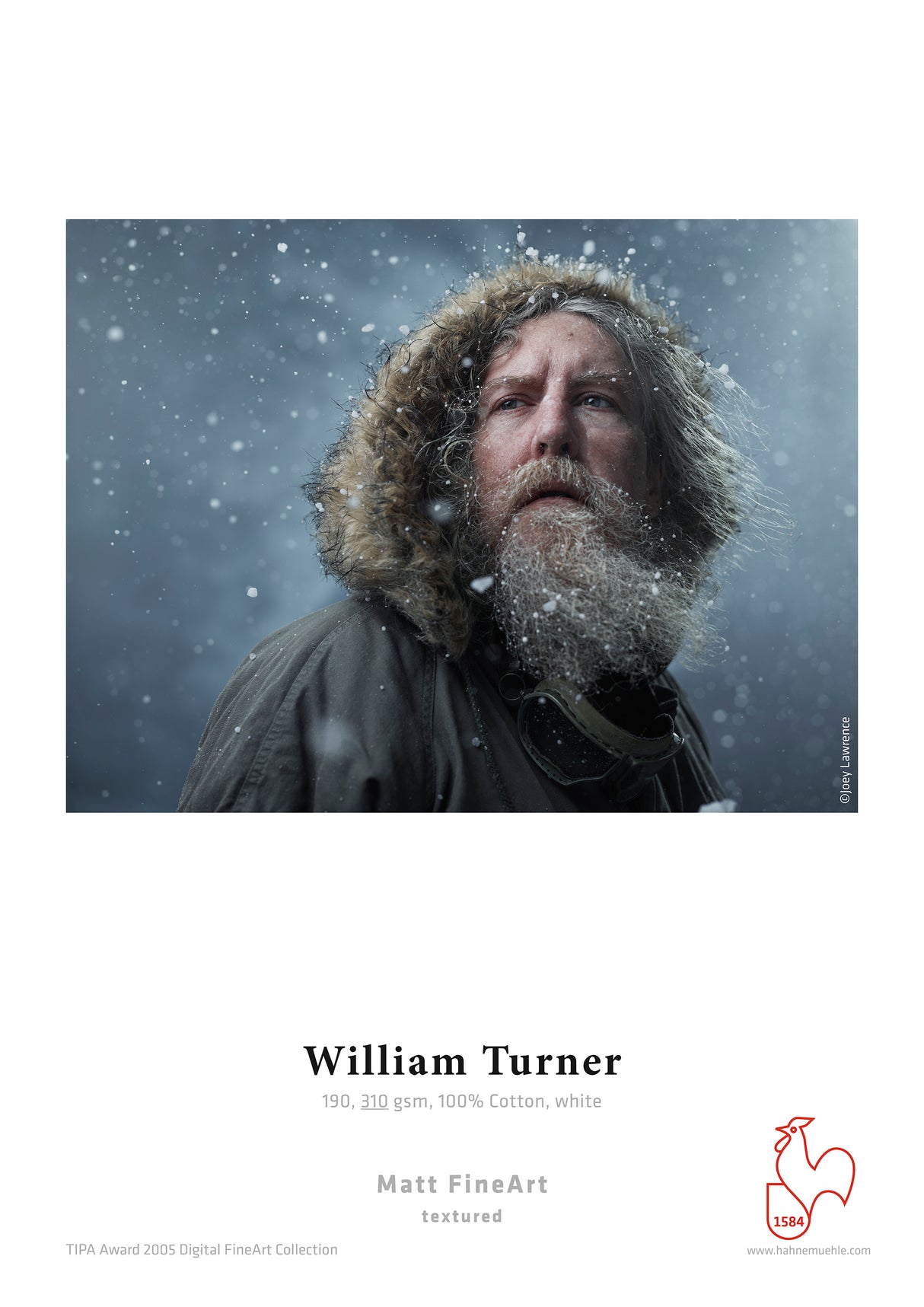 A bearded man in a fur-lined parka looks up as snow falls around him on a dark background. The white poster features Hahnemuhle William Turner 310 gsm, highlighting its textured, mould-made watercolour surface.