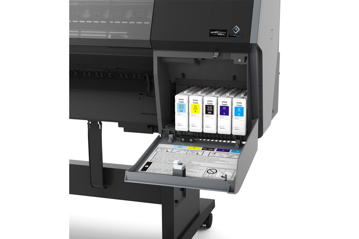 Close-up of the Epson SureColor P7370 24" Wide Printer (SCP7370SE) by Epson with its ink compartment open, showing six UltraChrome PRO10 Ink cartridges and a tray featuring instructions and warning symbols.