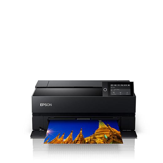 The Epson SureColor P700 13" Wide Photo Printer (C11CH38201) by Epson, in black, features a control panel and prints a photo of golden temple spires, shown against a plain white background.