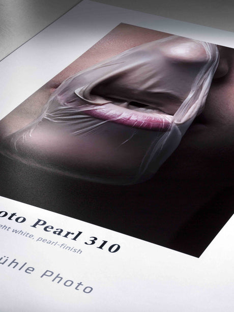 A close-up of a person's mouth, partly covered by translucent material, printed on glossy Hahnemuhle Photo Pearl 310 paper with a pearlescent finish and some partially visible text below.