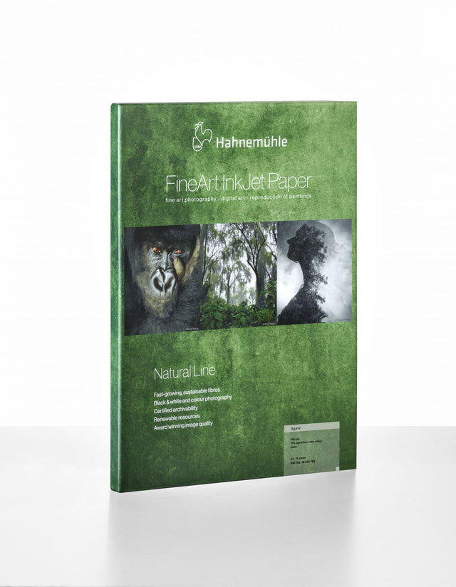 A green package of Hahnemuhle Agave Paper shows a gorilla, forest, and leaf silhouette, emphasizing its eco-friendly FineArt inkjet paper made from agave fibers.