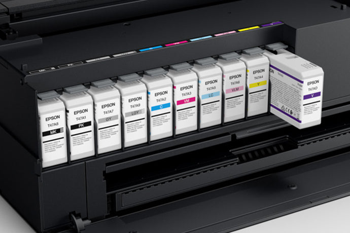 The image shows an Epson SureColor P900 17” Wide Photo Printer with an  Ultrachrome PRO10 ink cartridges inserted on a printer slots