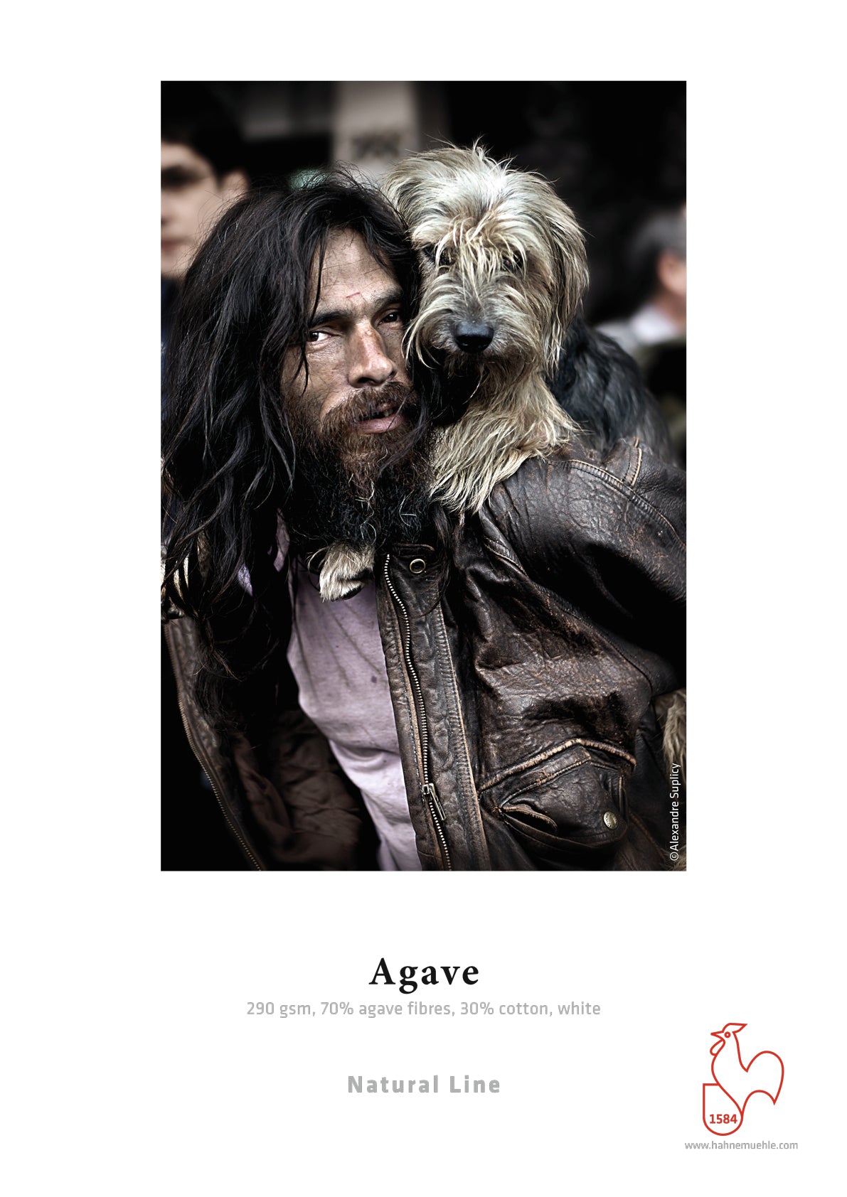 A man with long hair and a beard, in a brown leather jacket, stands outdoors as a shaggy dog rests its front legs on his shoulders. The image is labeled Hahnemühle Agave Paper by Hahnemuhle, printed on eco-friendly FineArt inkjet paper.