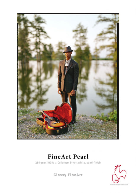 A man in a suit and hat stands by a lake with an open guitar case on the grass. Trees and water form the background. Below, text promotes Hahnemuhle FineArt Pearl art paper featuring its premium pearl inkjet coating.