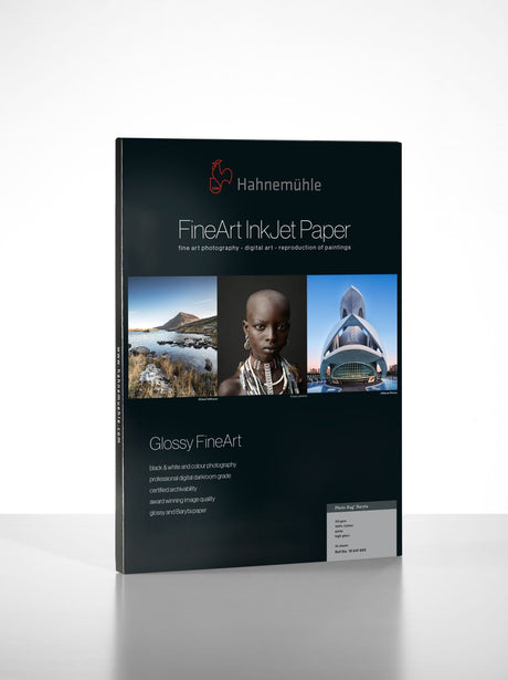 A pack of Hahnemuhle Photo Rag® Baryta, a fine art cotton inkjet paper, showcases three sample images with product details and specifications printed on the front.