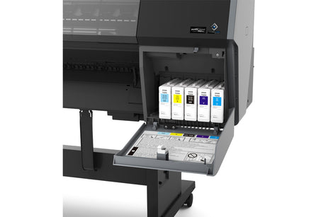Close-up of the Epson SureColor P7370 24" Wide Printer (SCP7370SE) by Epson with its ink compartment open, showing six UltraChrome PRO10 Ink cartridges and a tray featuring instructions and warning symbols.