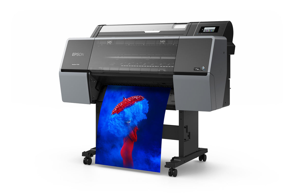 The Epson SureColor P7370 24" Wide Printer (SCP7370SE) by Epson prints vibrant images, like a person in red with a red hat and blue smoke on a white background—ideal for professional photography printing.