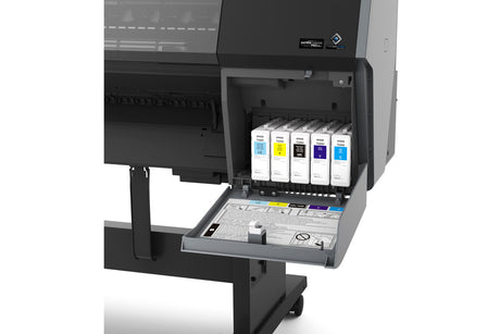 Close-up of an open ink compartment on the Epson SureColor P9370 44" Wide Printer, showing six labeled UltraChrome PRO10 ink cartridges in various colors arranged in a pull-out drawer.