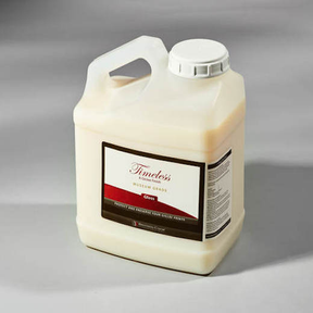 A large plastic container with a handle and white screw cap, labeled Breathing Color Timeless Matte - 1 Gallon, offers UV protection to preserve art or surfaces. It sits on a plain, light gray surface.