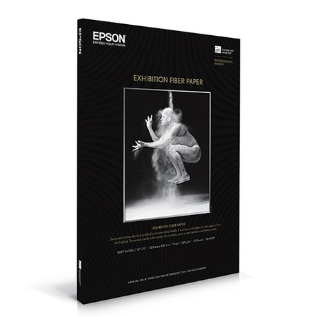 Epson Exhibition Fiber Paper box showing a surreal black-and-white photo of a dancer surrounded by dust; text highlights the papers features and dimensions for professional photo printing.