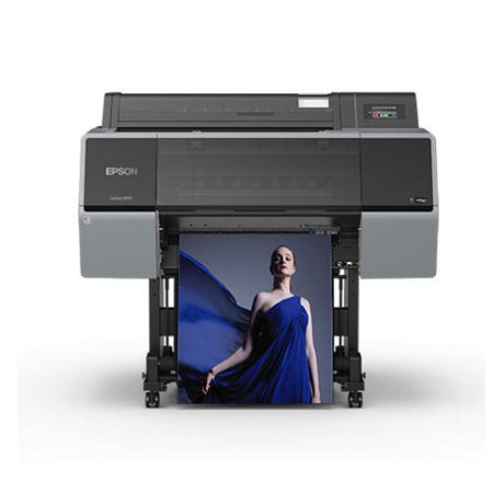 The Epson SureColor P7570 24” Wide Printer (SCP7570SE) uses UltraChrome PRO12 Ink to print a vibrant, high-quality poster of a woman in a flowing blue dress. The black and gray Epson printer stands on wheels against a plain white background.