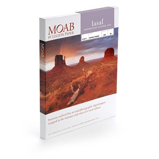 A box of MOAB Lasal Exhibition Luster, premium archival luster paper, shown with a red rock desert landscape and mesas under a dramatic sky—ideal for exhibition-quality photo prints.